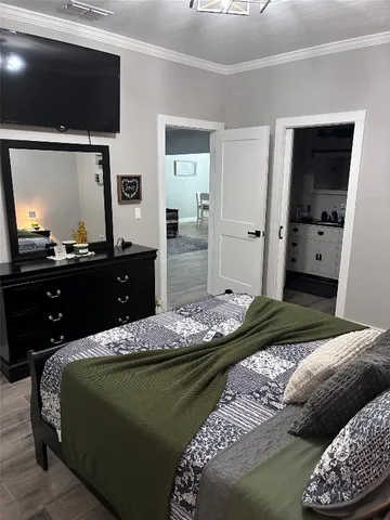 a bedroom with a bed and a flat screen tv