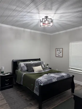 a bedroom with a bed and a chandelier