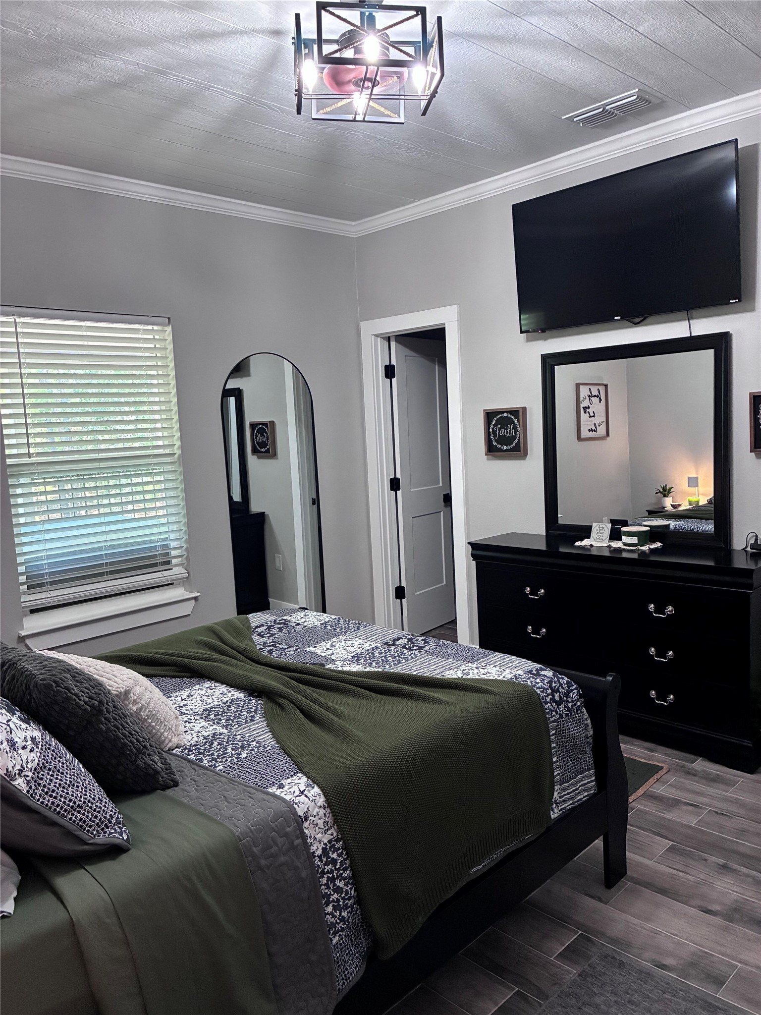 1135 Red Fox Road La Grange, TX 78945 - Photo 19 of 32 a bedroom with a bed and a flat screen tv