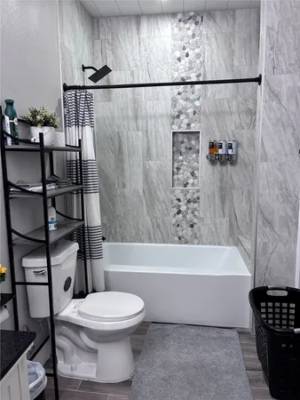 a bathroom with a toilet and a shower