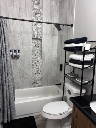 a bathroom with a toilet a sink and bathtub