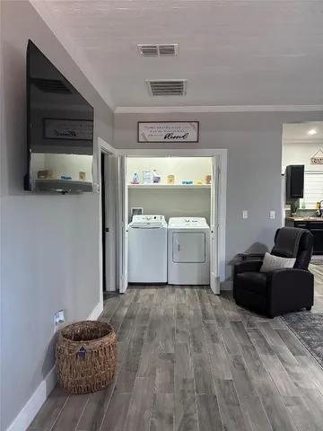 a living room with furniture a rug and a table