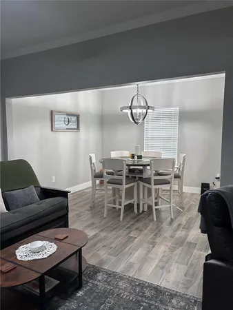 a living room with furniture a rug and white walls