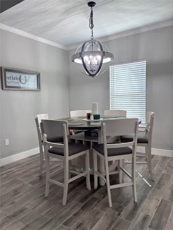 a view of a dining room with furniture wooden floor and a chandelier