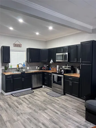 a kitchen with stainless steel appliances wooden cabinets and granite counter tops