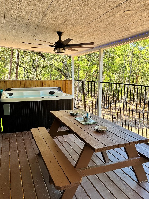 1135 Red Fox Road La Grange, TX 78945 - Photo 9 of 32 Deck featuring outdoor dining space, ceiling fan, and a hot tub