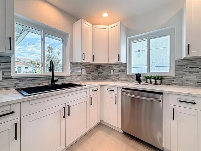 a dining room with furniture a rug and a large window
