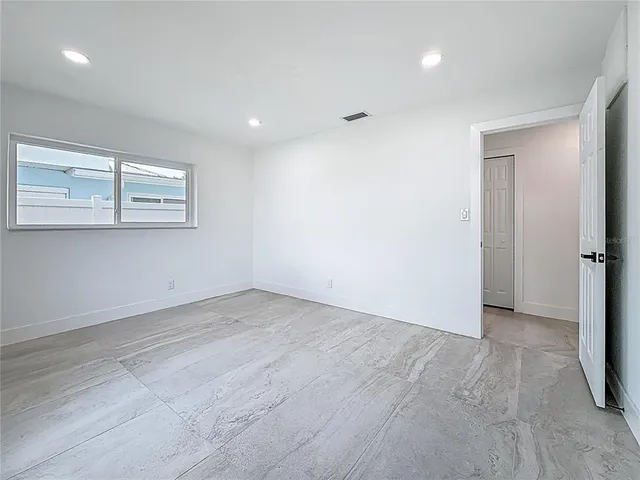 a bedroom with a bed and a mirror