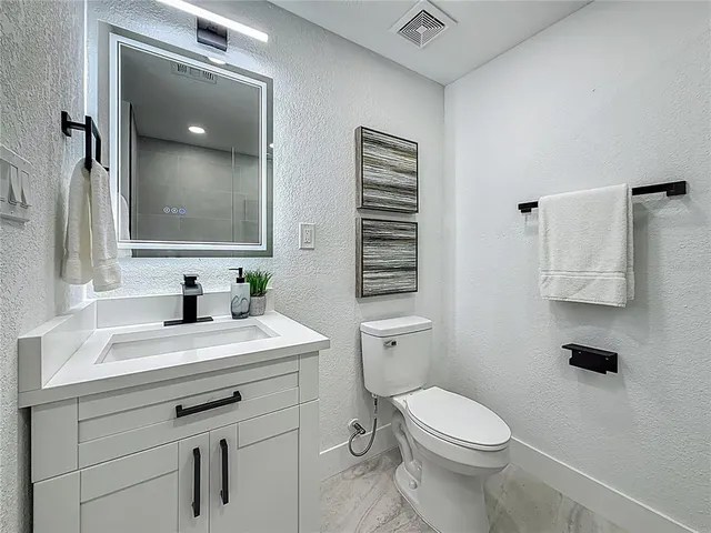 a view of a house with a backyard porch and sitting area