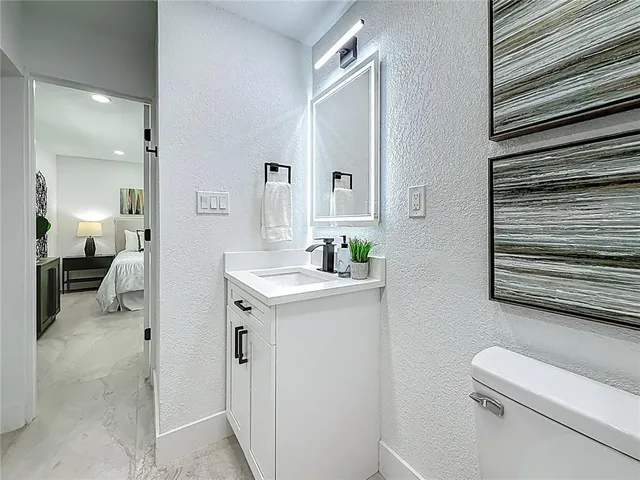 a front view of a house with porch and garden