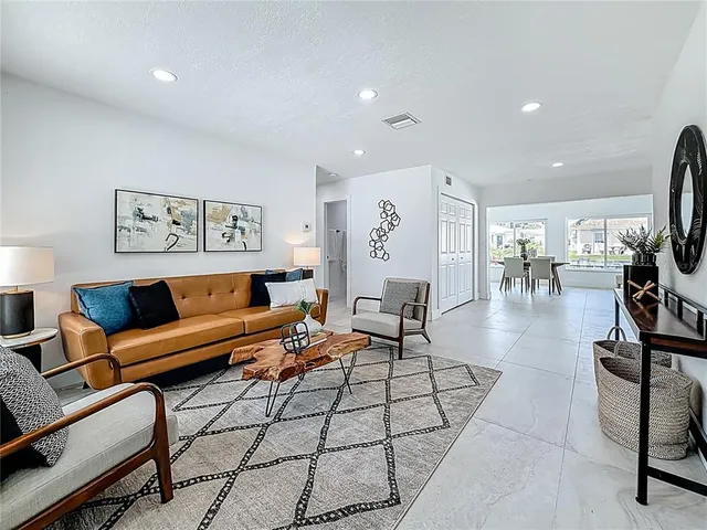 a living room with furniture and a potted plant