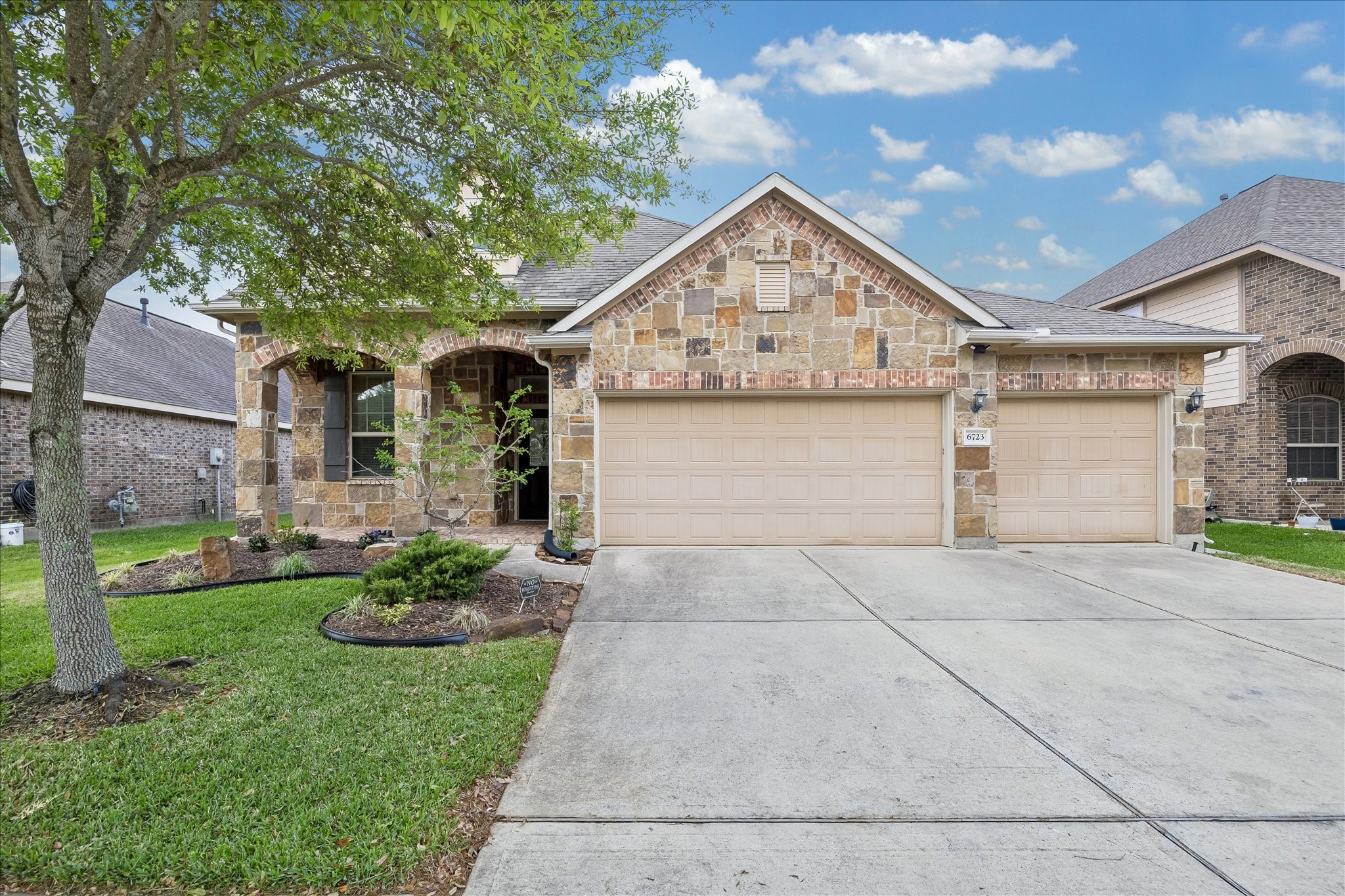6723 Hunters Way Lane Baytown, TX 77521 - Photo 1 of 16 Home with a wide driveway leads to a three-car garage.