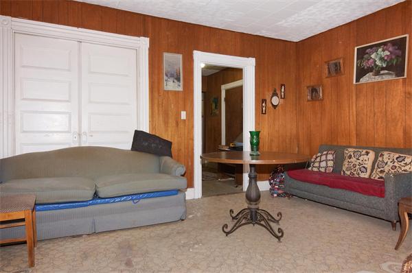 152 Harvard Street, Unit 2 Brookline, MA 02446 - Photo 3 of 11 a bedroom with a bed and a chair in it