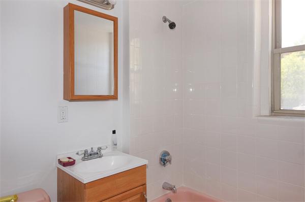 152 Harvard Street, Unit 2 Brookline, MA 02446 - Photo 7 of 11 a bathroom with a sink mirror and vanity