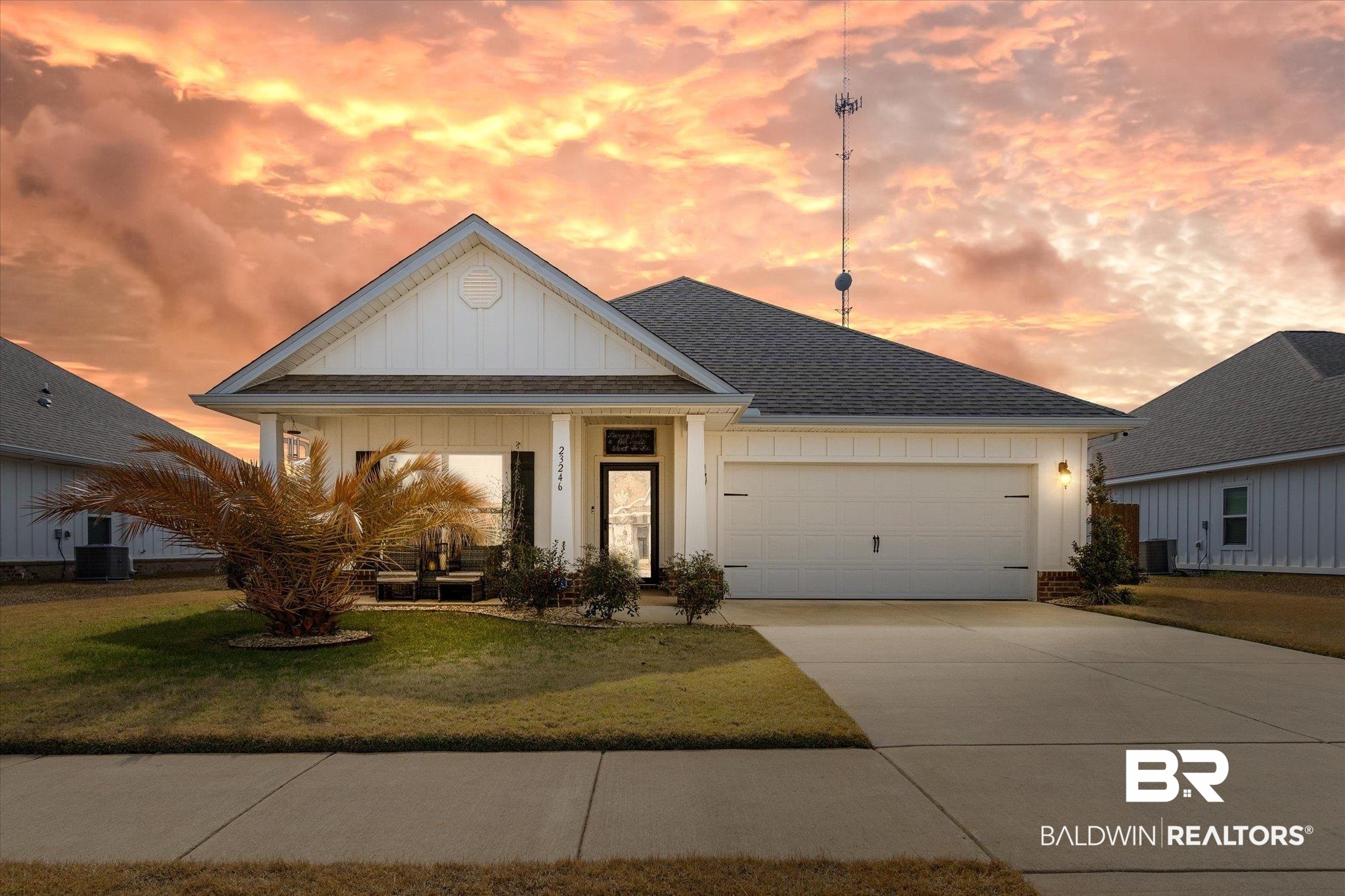 23246 Lieutenant Avenue Foley, AL 36535 - Photo 1 of 36 View of front of house with a garage, central AC, and a lawn