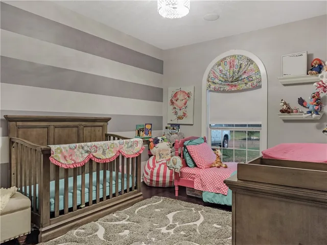 a bedroom with bed and a chandelier