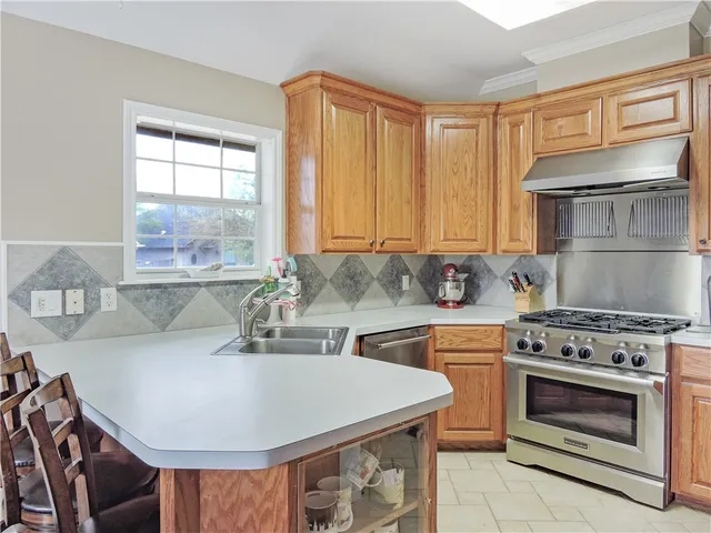 a kitchen with a stove a sink and a cabinets