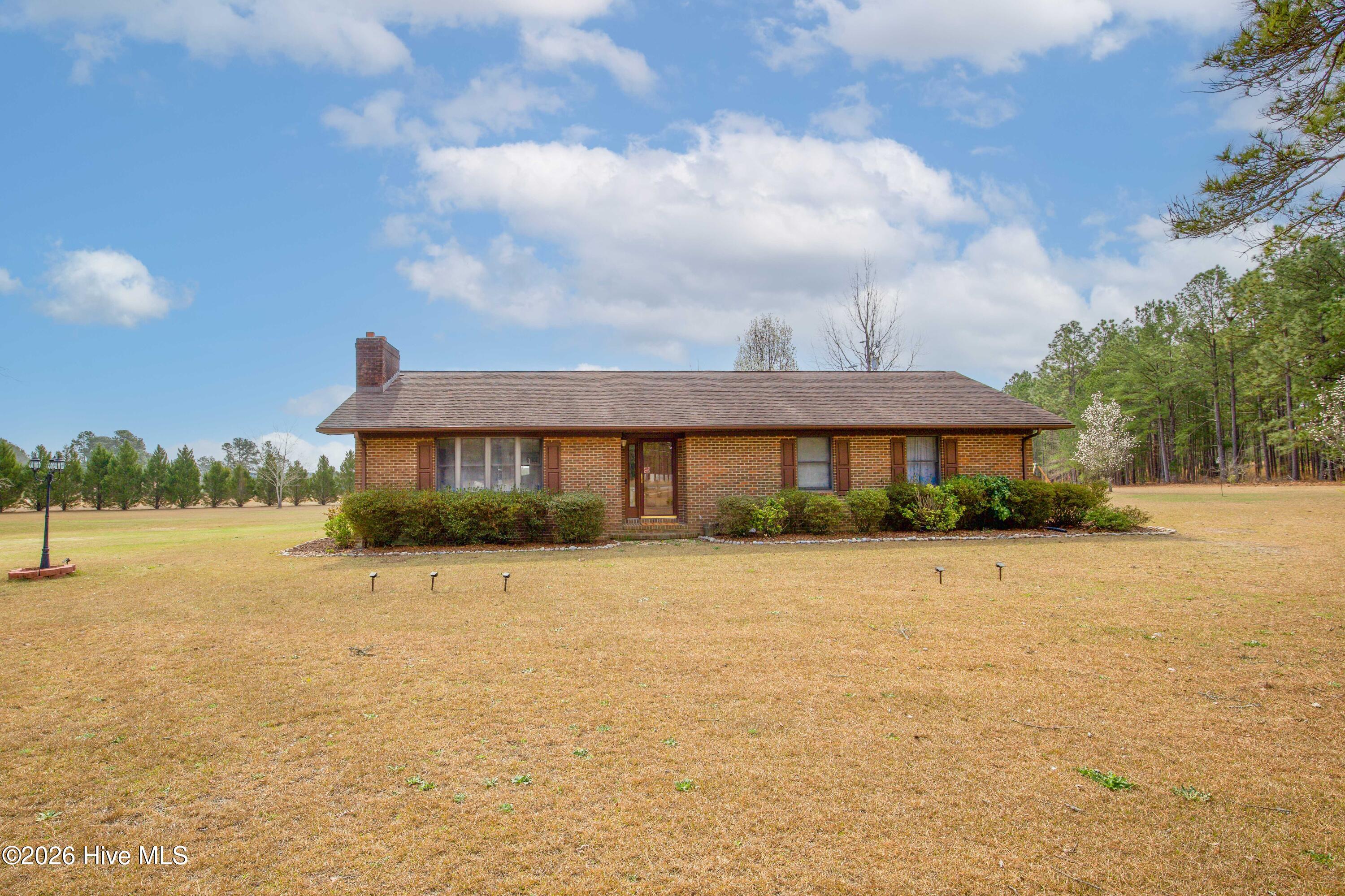 124 Joseph Road Aberdeen, NC 28315 - Photo 1 of 59 Front exterior view of the brick ranch home at 124 Joseph Road in Aberdeen, NC showing single-level living on over 5 acres with no HOA and convenient access to Southern Pines, Pinehurst, and US-1.
