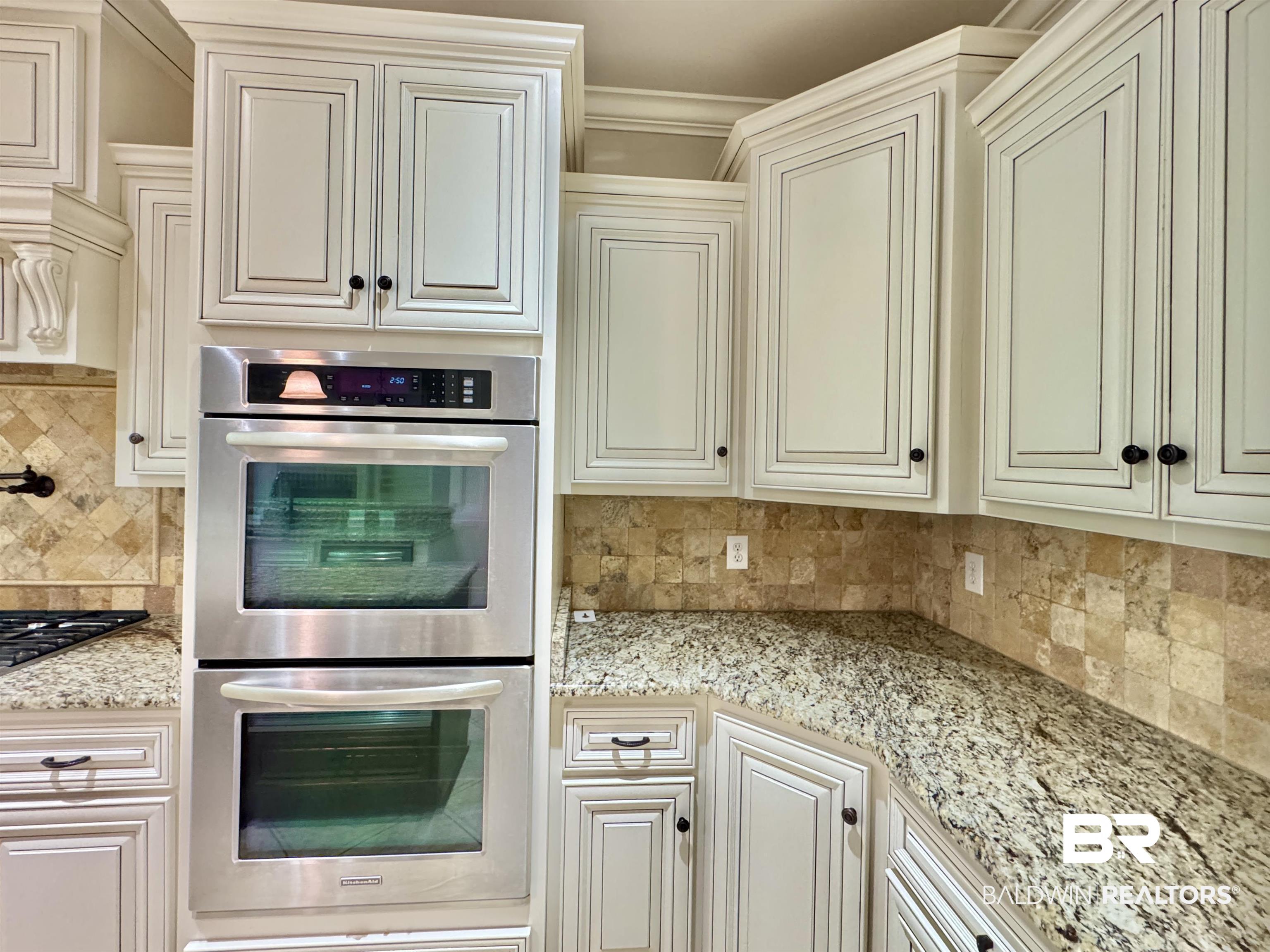 10846 County Road 138 Bay Minette, AL 36507 - Photo 25 of 53 Kitchen with crown molding, light stone countertops, stainless steel appliances, and tasteful backsplash
