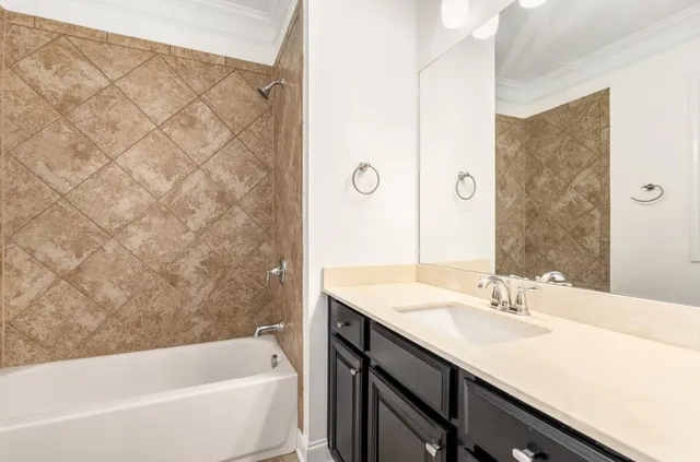 a bathroom with a tub sink and mirror