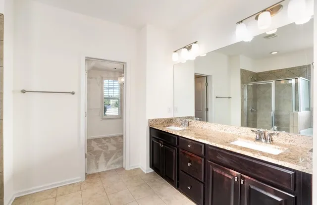 a bathroom with a granite countertop sink mirror and a