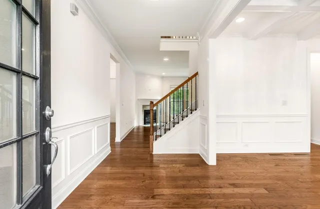 a view of staircase with lots of frames on wall and a window