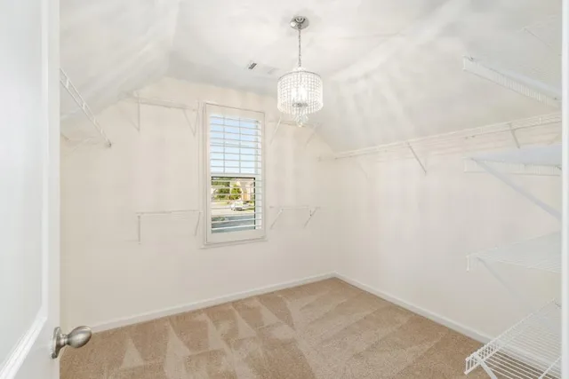 en empty room with windows and ceiling fan