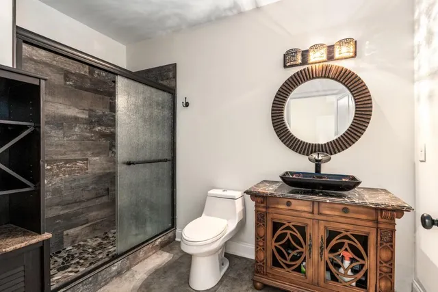 a bathroom with a toilet a sink and a mirror