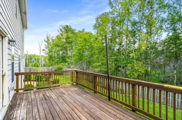 a view of balcony with wooden floor and fence