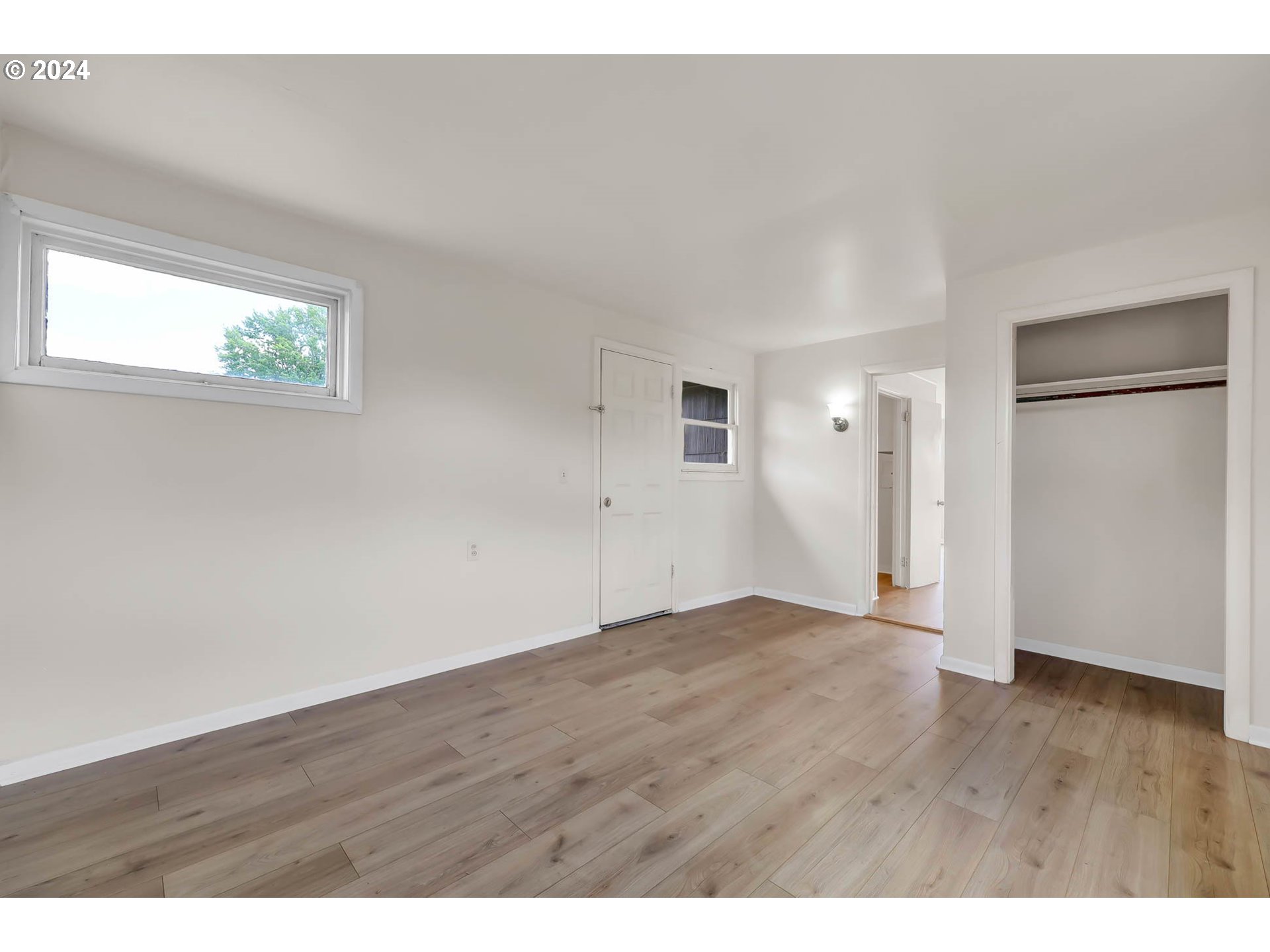 2915-2925 Oak Street Eugene, OR 97405 - Photo 12 of 42 a view of an empty room with wooden floor and closet