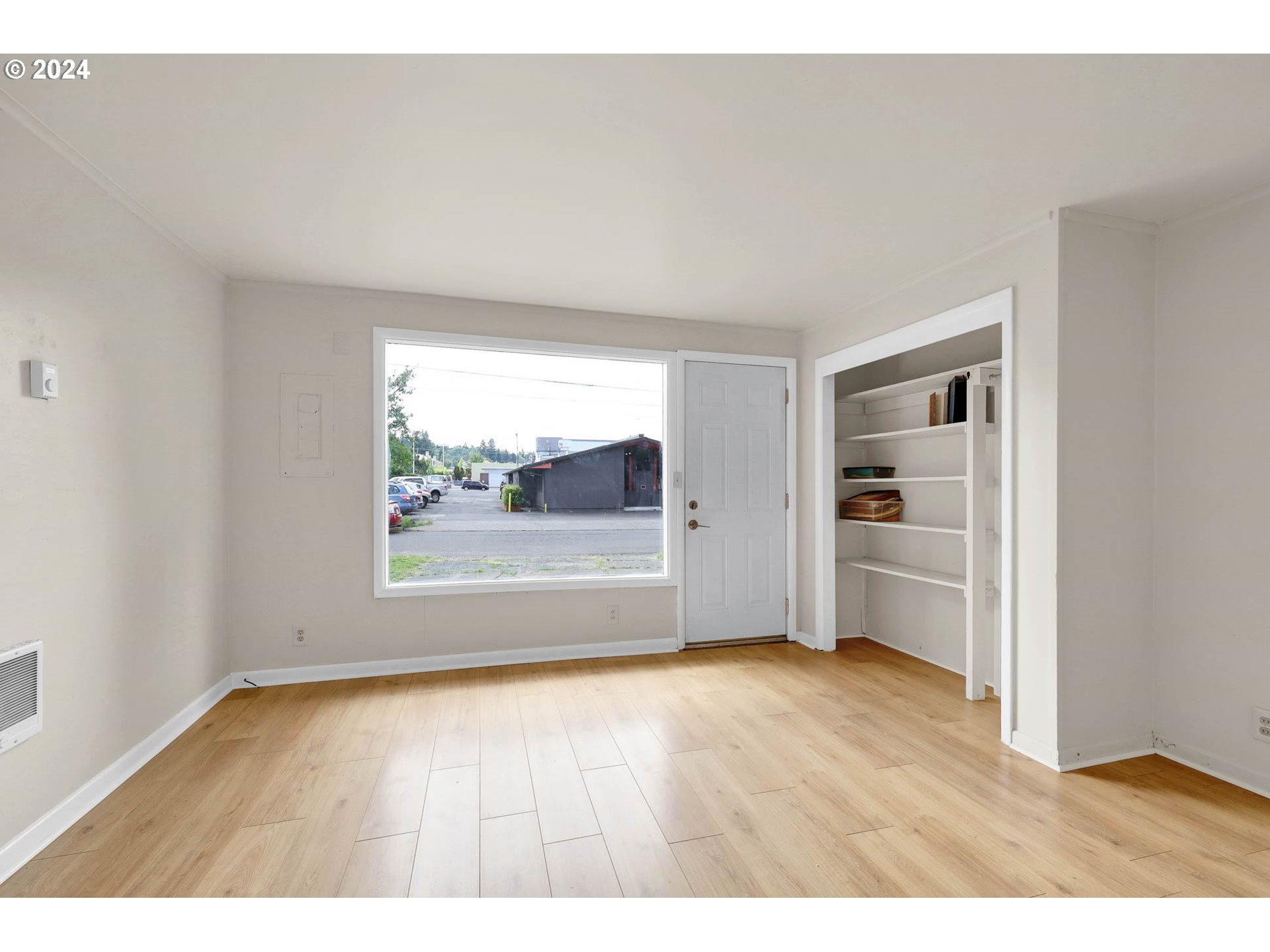 2915-2925 Oak Street Eugene, OR 97405 - Photo 14 of 42 a view of an empty room with a window and wooden floor