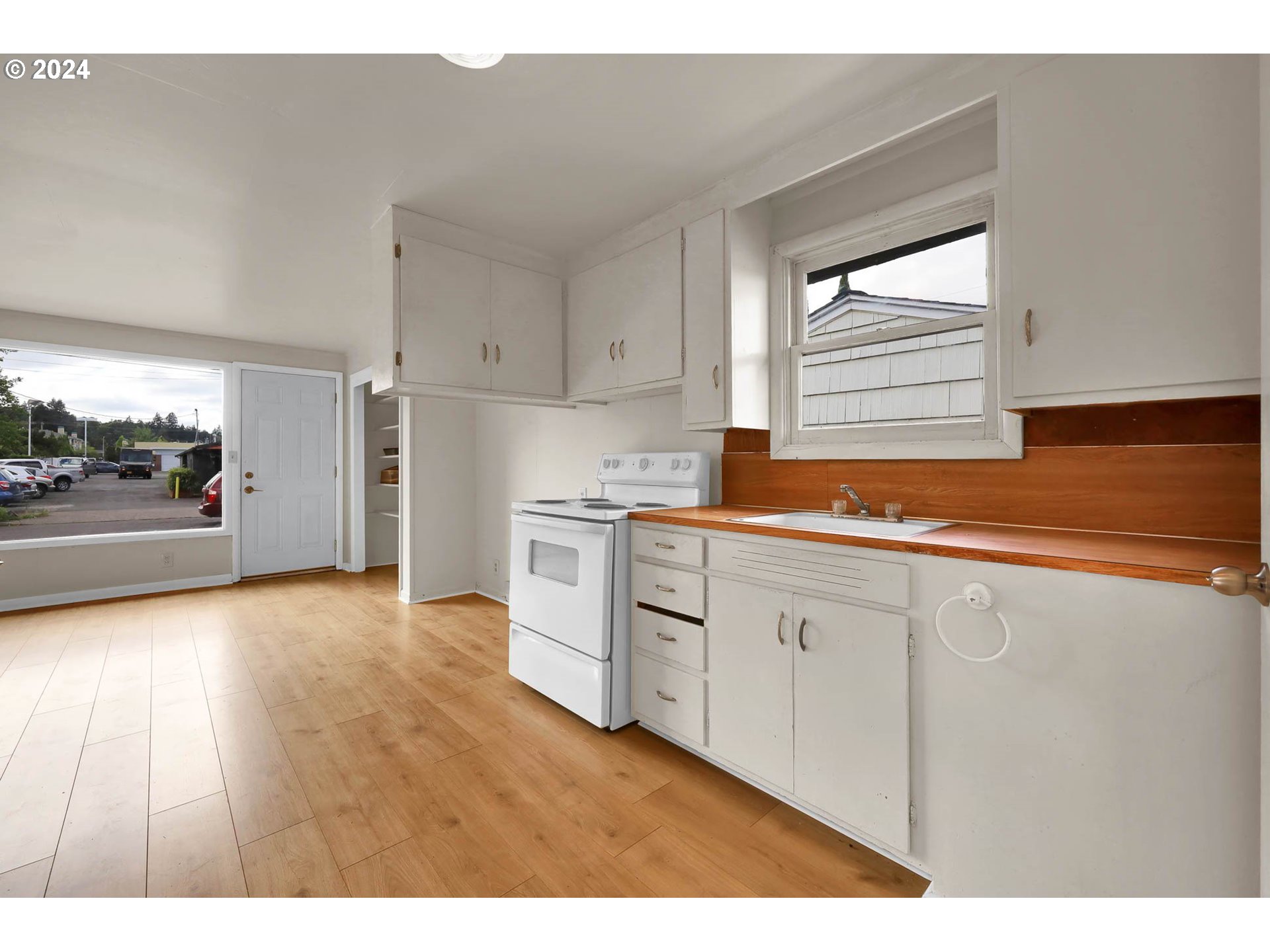 2915-2925 Oak Street Eugene, OR 97405 - Photo 8 of 42 a kitchen with granite countertop white cabinets and white appliances
