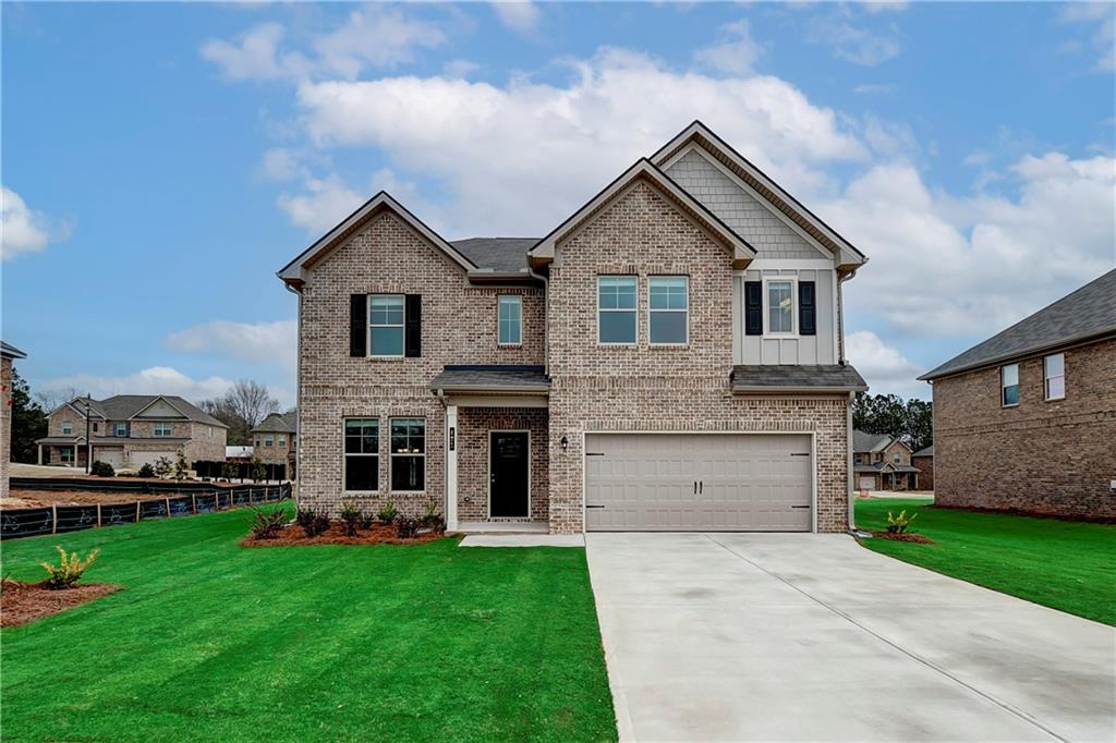 a front view of a house with a yard and garage