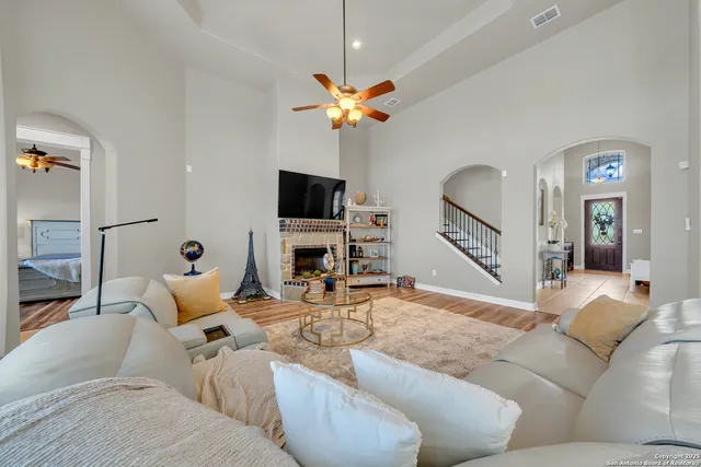 a living room with furniture a fireplace and a flat screen tv