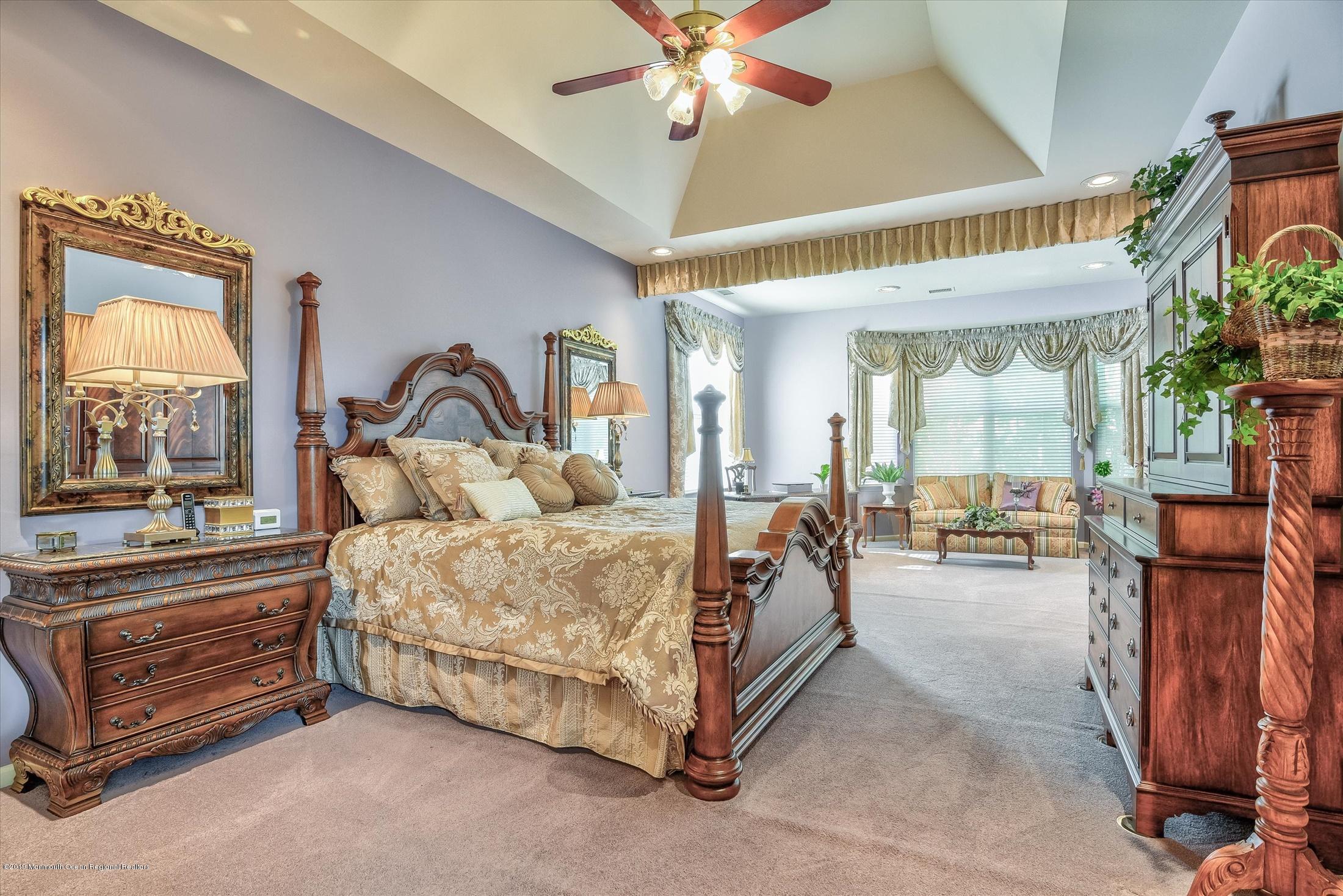 47 Portchester Drive Jackson, NJ 08527 - Photo 20 of 46 a bed room with a bed and a chandelier