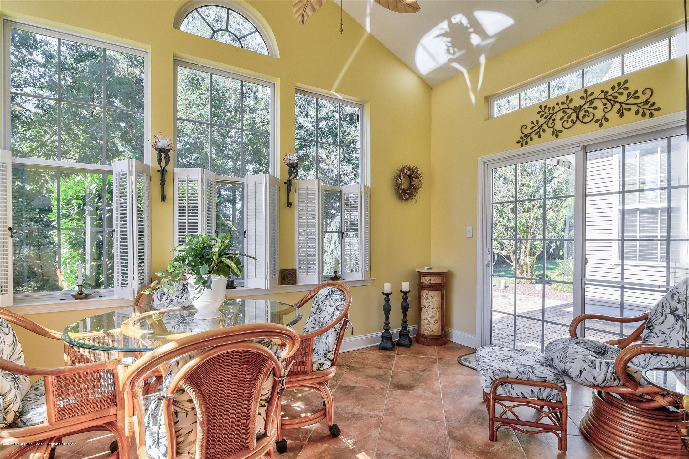 47 Portchester Drive Jackson, NJ 08527 - Photo 21 of 46 a view of a dining room with furniture a chandelier and large windows