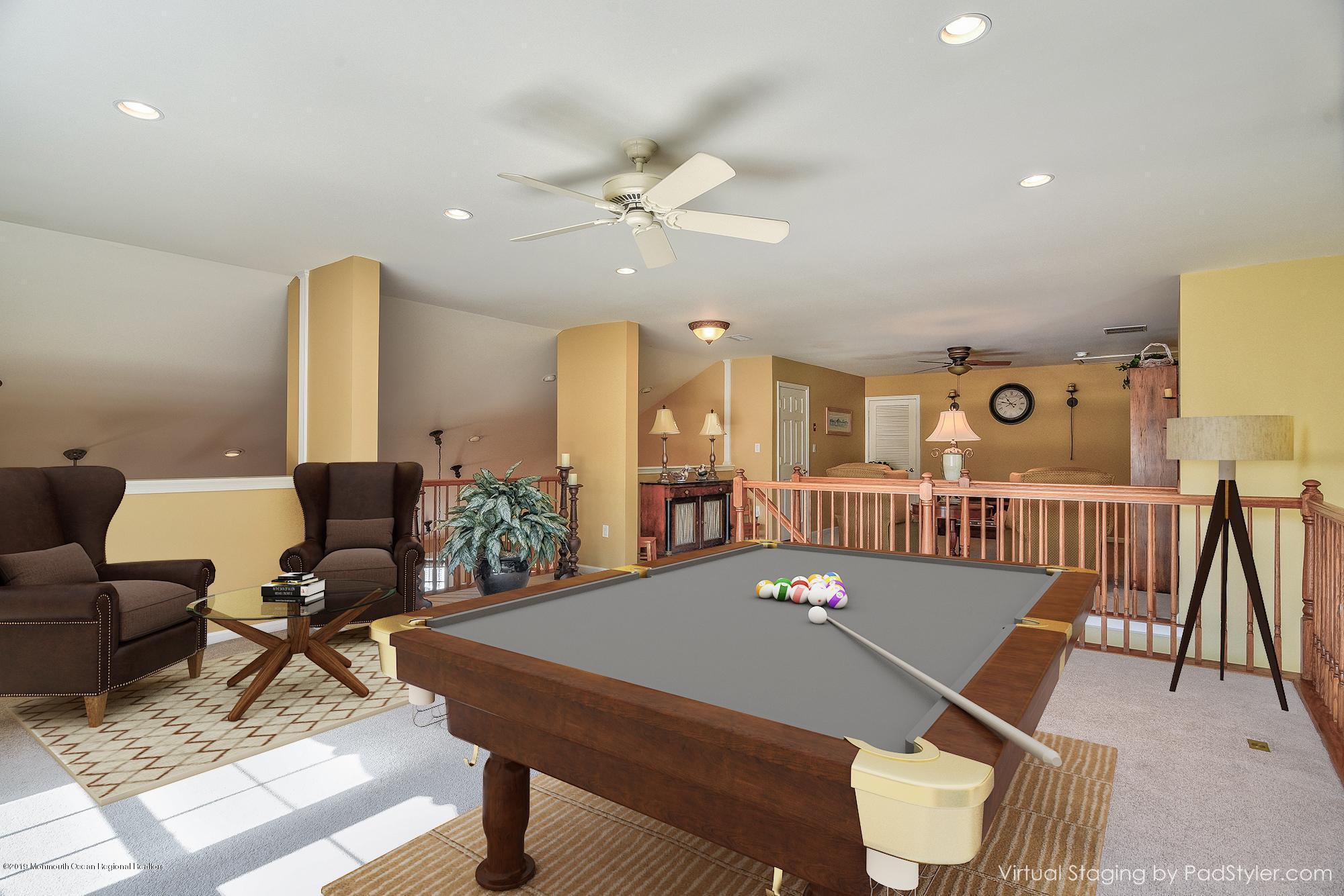 47 Portchester Drive Jackson, NJ 08527 - Photo 28 of 46 a living room with furniture a rug and a chandelier