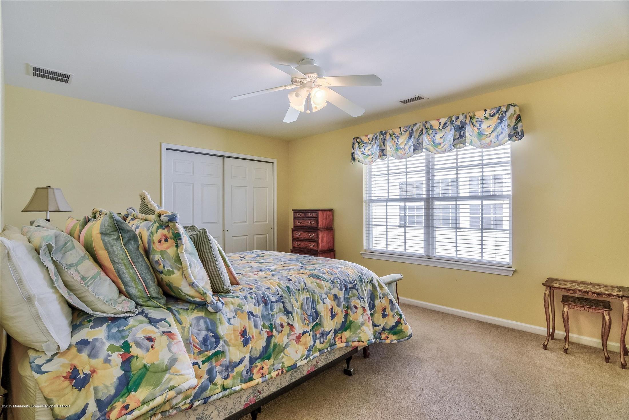 47 Portchester Drive Jackson, NJ 08527 - Photo 31 of 46 a bedroom with a bed and a chandelier