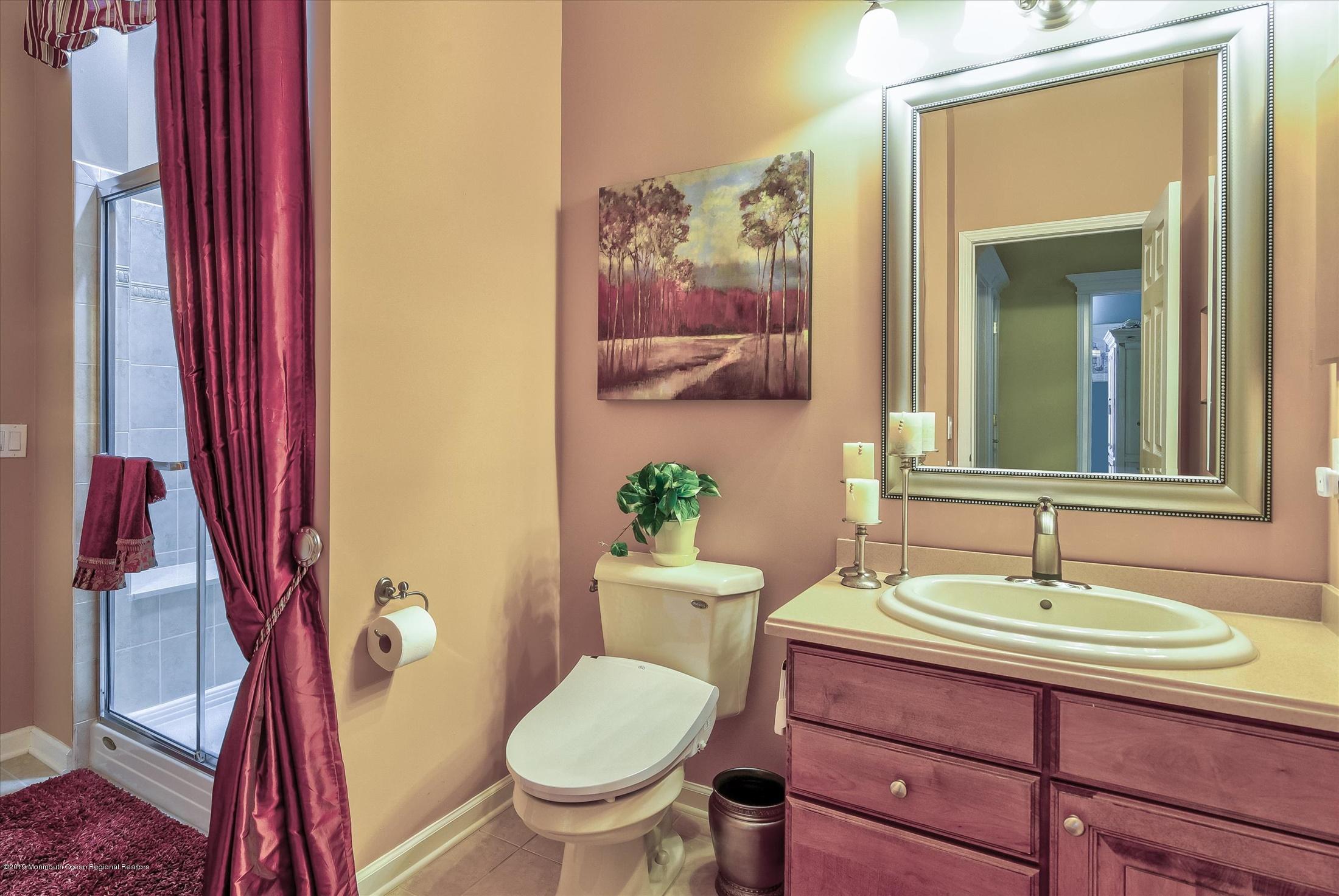 47 Portchester Drive Jackson, NJ 08527 - Photo 32 of 46 a bathroom with a sink and a mirror