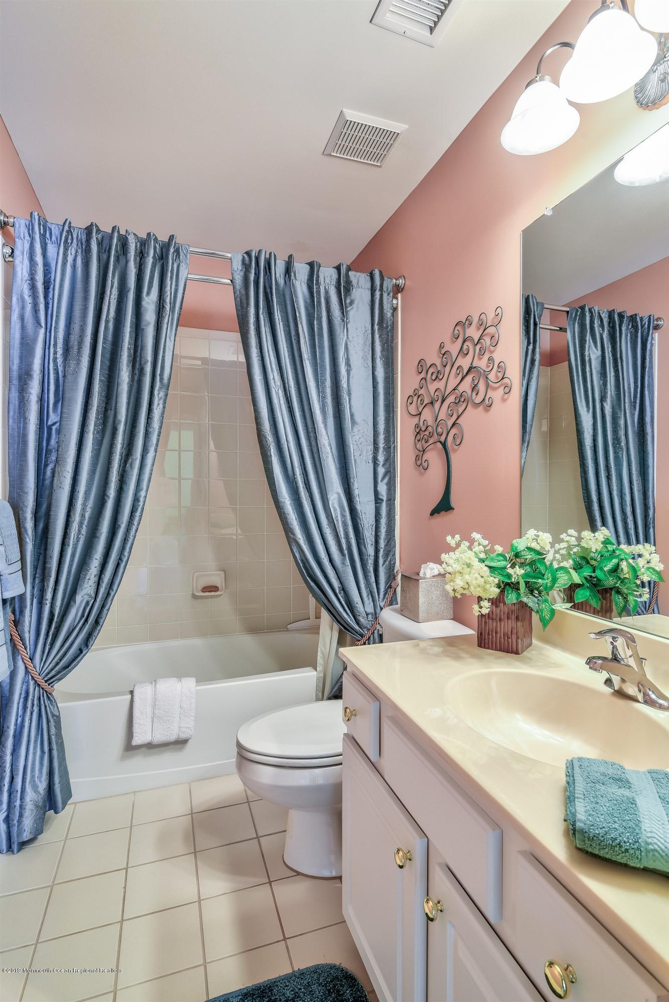 47 Portchester Drive Jackson, NJ 08527 - Photo 34 of 46 a bathroom with a granite countertop sink and a mirror