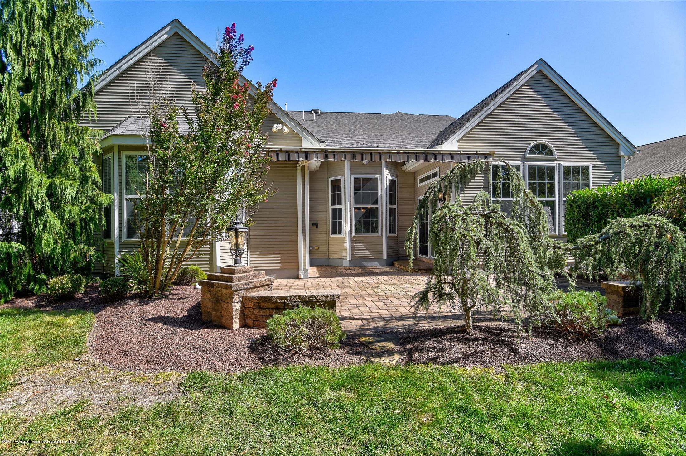 47 Portchester Drive Jackson, NJ 08527 - Photo 36 of 46 a front view of a house with a garden and porch