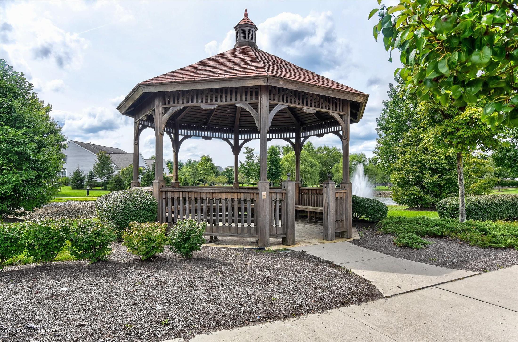 47 Portchester Drive Jackson, NJ 08527 - Photo 45 of 46 a view of a deck with a table and chairs under an umbrella
