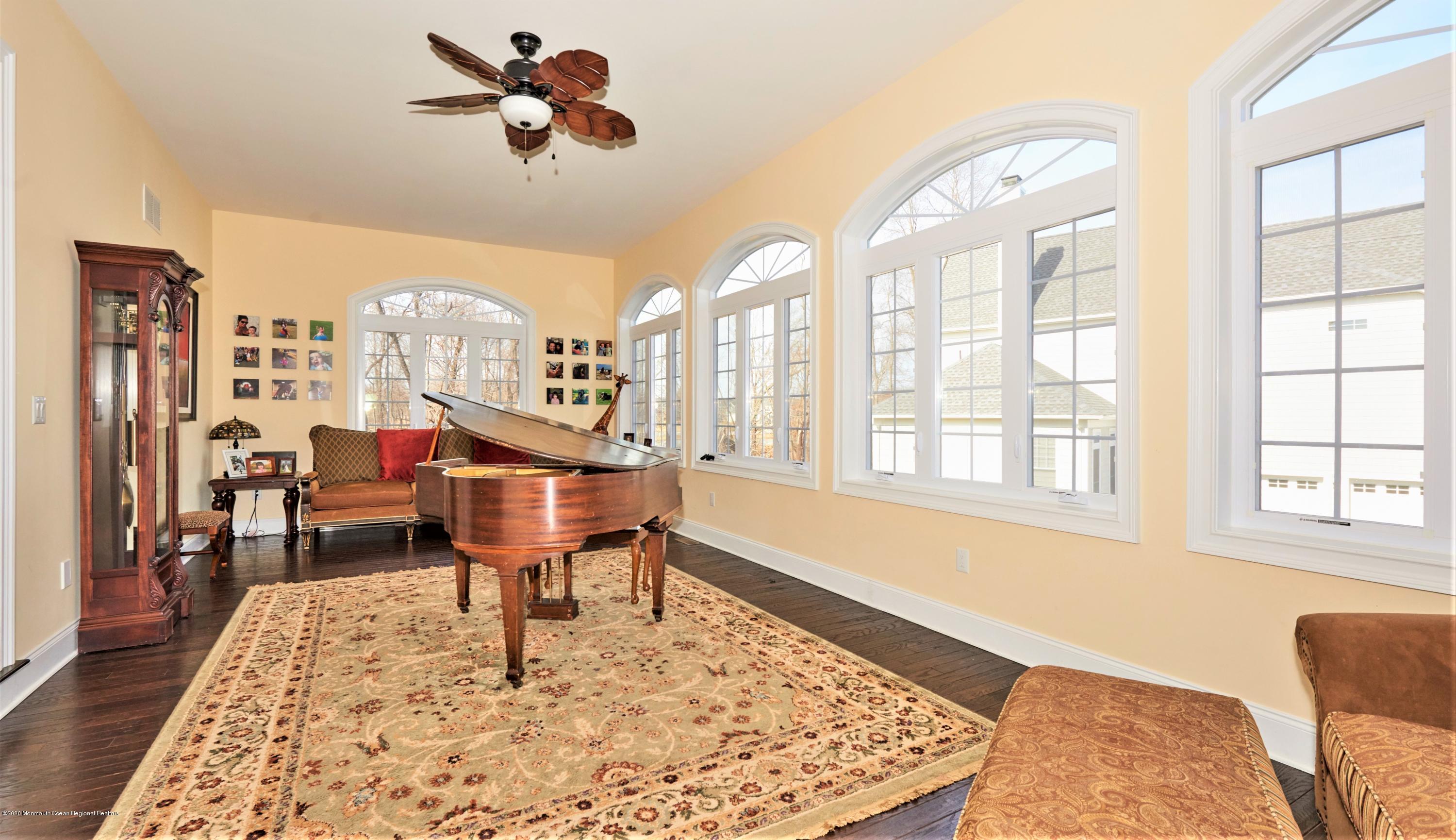 15 Windermere Road Lincroft, NJ 07738 - Photo 17 of 56 a living room with furniture a rug and a chandelier