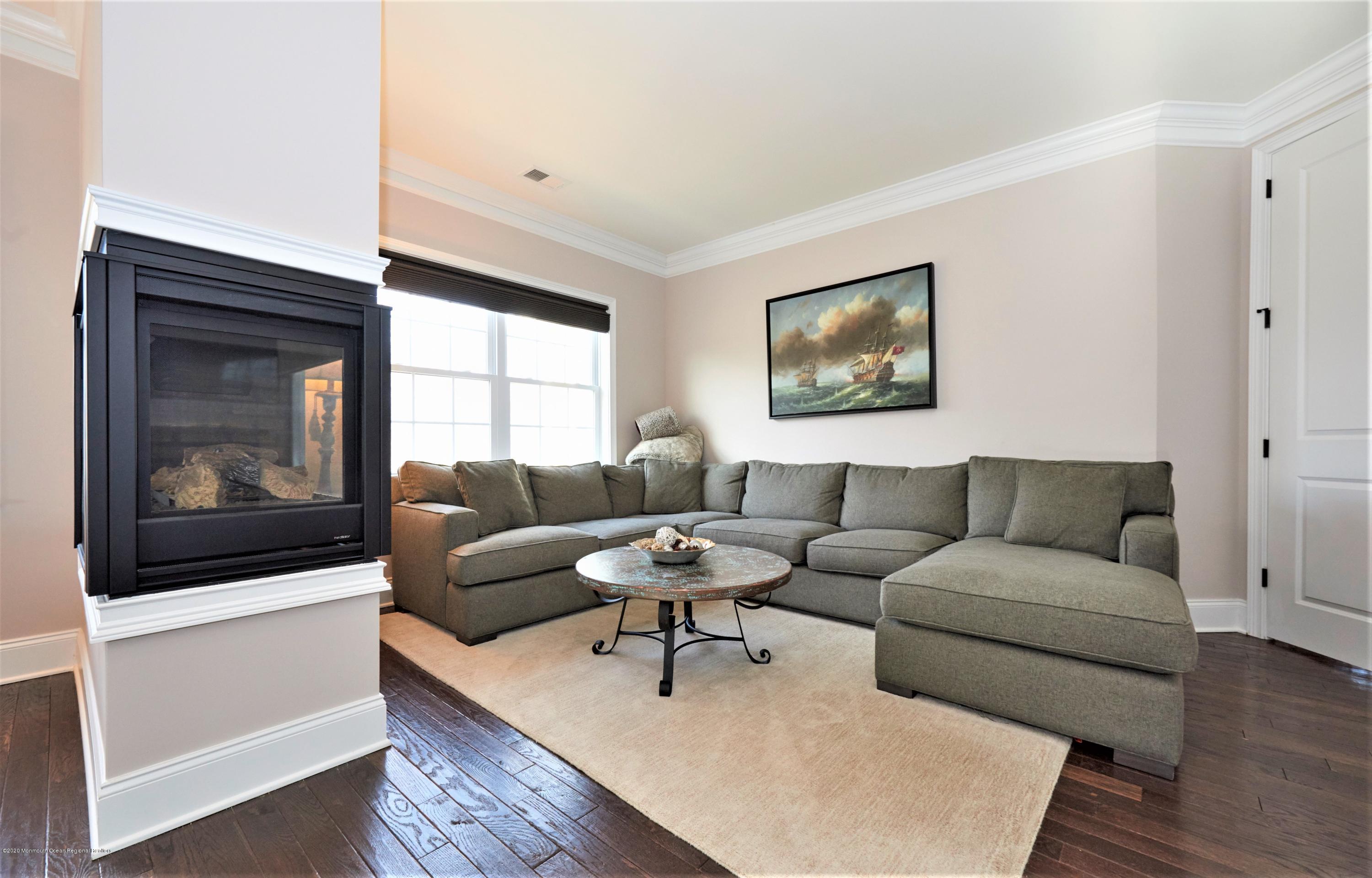 15 Windermere Road Lincroft, NJ 07738 - Photo 26 of 56 a living room with furniture and a fireplace
