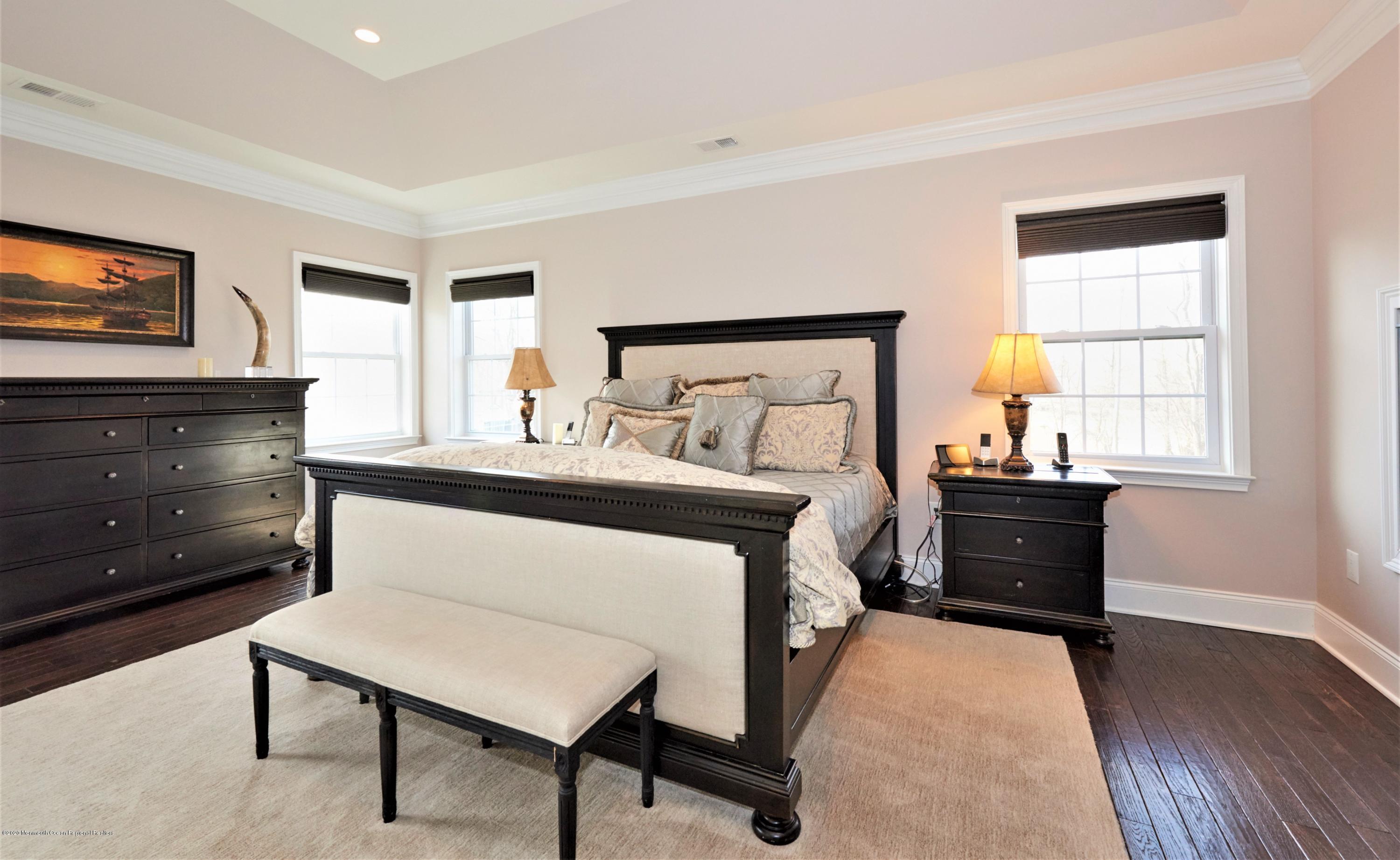 15 Windermere Road Lincroft, NJ 07738 - Photo 28 of 56 a bedroom with furniture and a flat screen tv