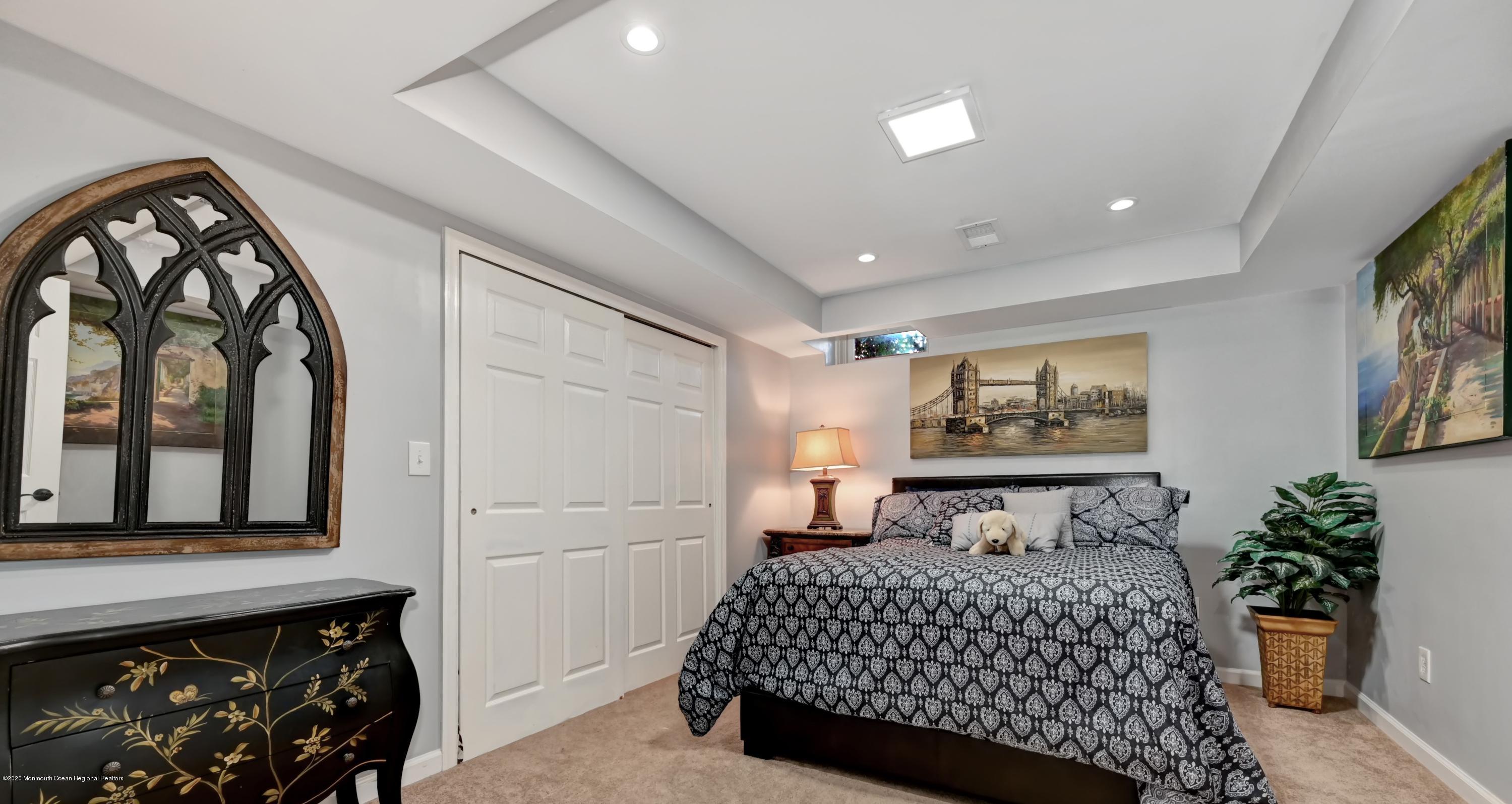 15 Windermere Road Lincroft, NJ 07738 - Photo 38 of 56 a bedroom with a bed and a painting on the wall