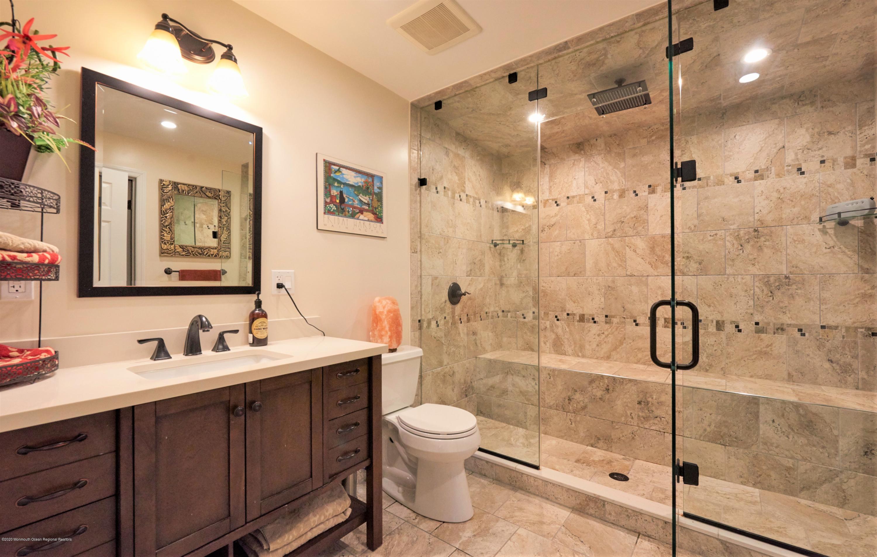 15 Windermere Road Lincroft, NJ 07738 - Photo 40 of 56 a bathroom with a double vanity sink toilet mirror and shower