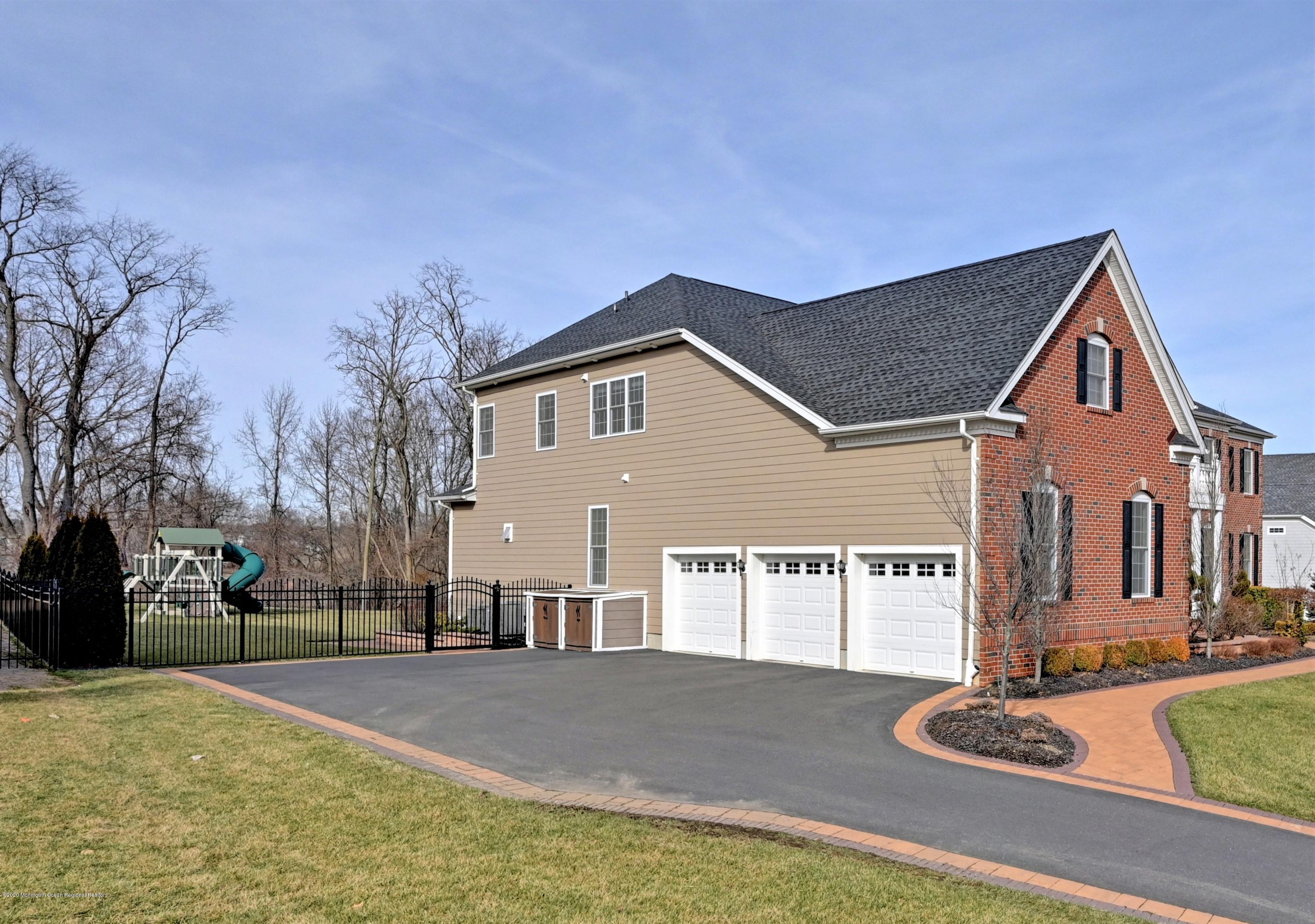15 Windermere Road Lincroft, NJ 07738 - Photo 43 of 56 a view of a house with snow on the road
