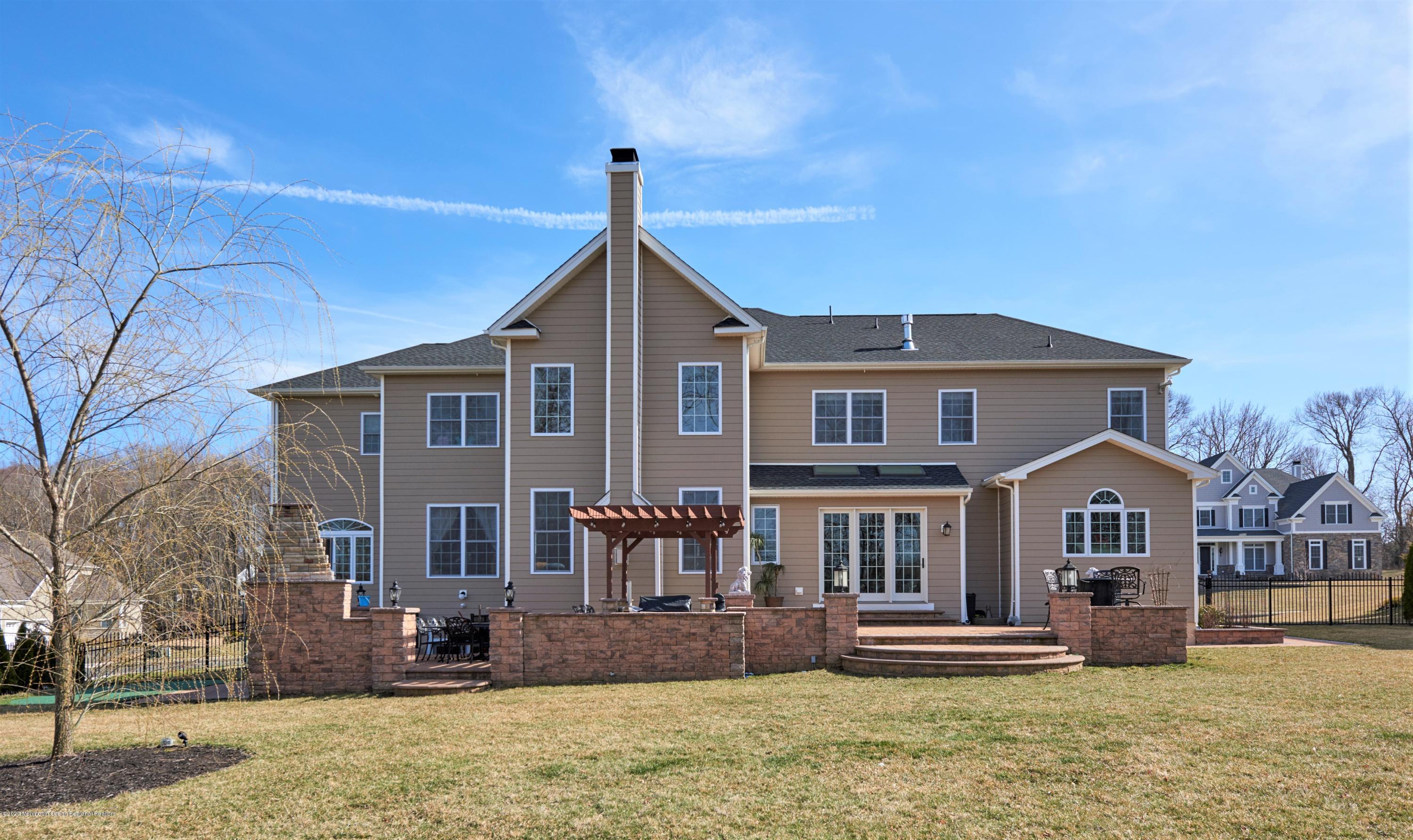 15 Windermere Road Lincroft, NJ 07738 - Photo 44 of 56 a front view of a house with a yard