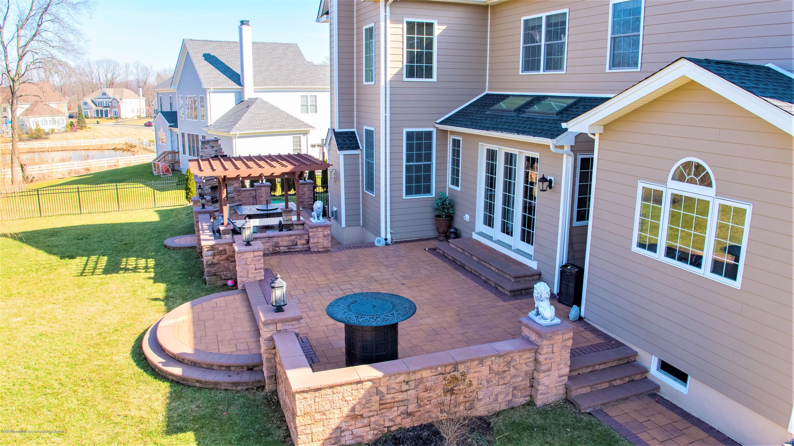 15 Windermere Road Lincroft, NJ 07738 - Photo 45 of 56 a front view of a house with swimming pool
